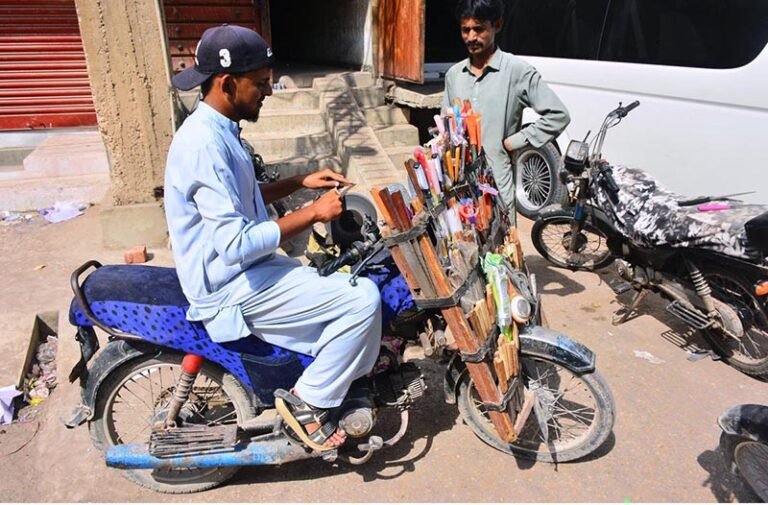 A blacksmith is sharpening customers’ knives using a mobile service in the Dadan Shah Colony area.