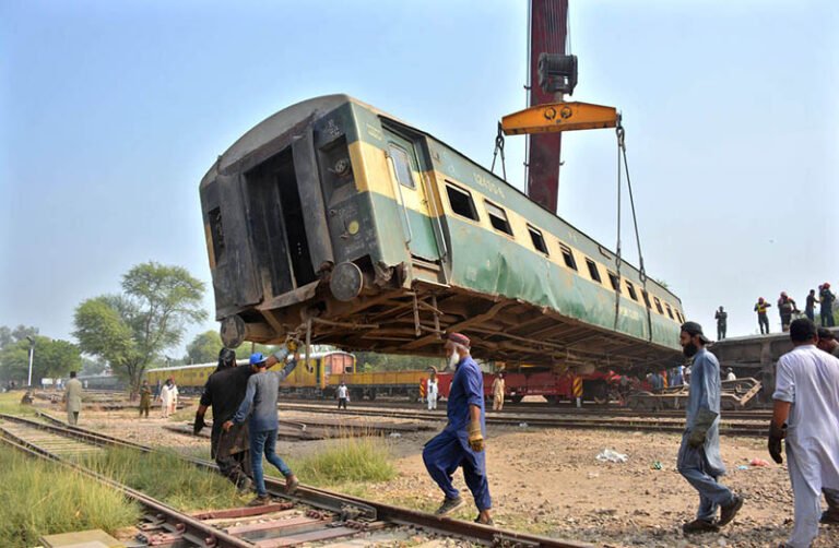 A crane lifts a derailed coach of the Rehman Baba Express during rescue and recovery operations near Sher Shah Railway Station at least four passengers were killed and 49 injured in the incident.