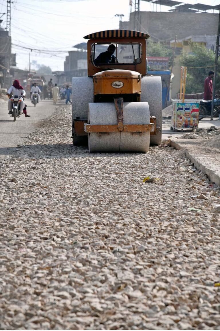 A driver operates a road roller to level a road under construction a part of development project in Baka Pur village.