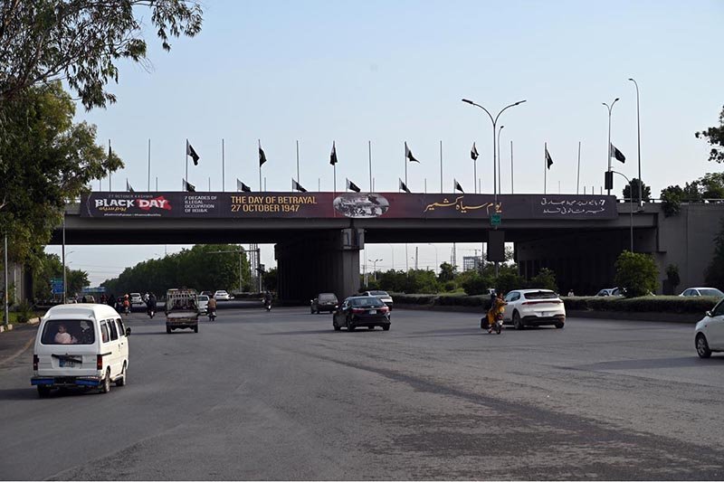 A large banner is displayed on Zero Point Bridge in connection with the upcoming Kashmir Black Day on October 27, as traffic flows underneath in the Federal Capital