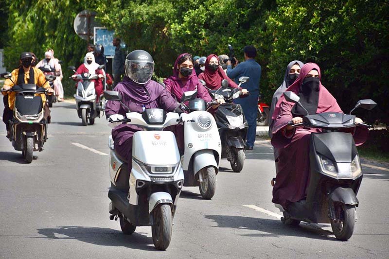 Women participate in a road safety awareness scooter rally organized by the Road Safety Club at the University of Agriculture Faisalabad in collaboration with City Traffic Police