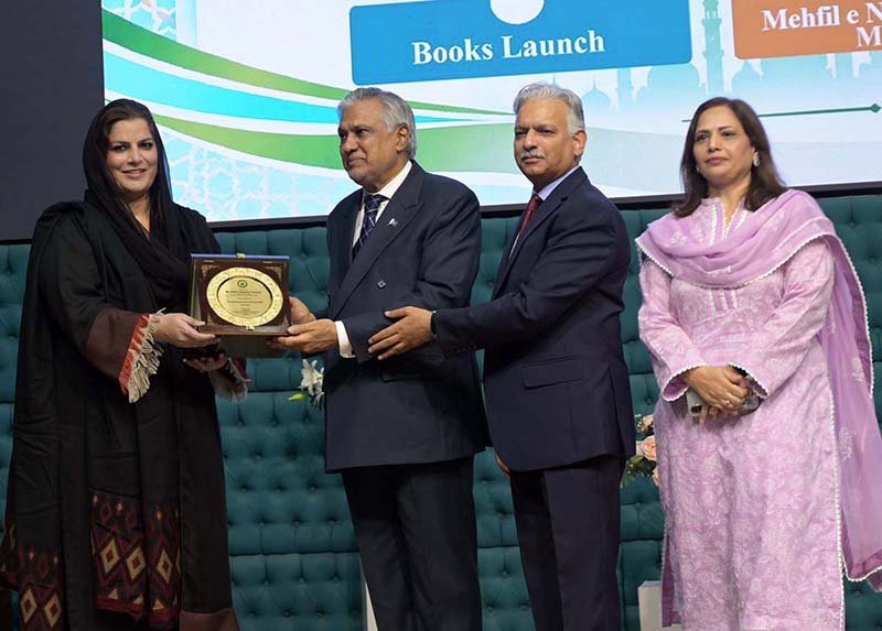 Deputy Prime Minister and Foreign Minister Mohammad Ishaq Dar presents a shield to Parliamentary Secretary Rabia Naseem Farooqi during the 3rd International Seerat Festival, themed “Building Bridges Among Nations,” organized by the National Rahmatul-lil- Alameen wa Khatam-un-Nabiyyin Authority.