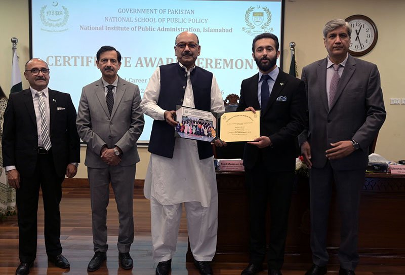 Secretary, Establishment Division, Barrister Nabeel A. Awan presents certificates to participants during the passing-out ceremony of the 47th Mid-Career Management Course at NIPA