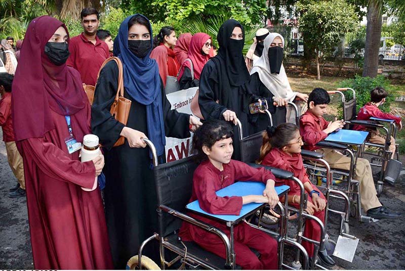 Participants march during an awareness walk organized by the Eilya Care Foundation to mark World White Cane Safety Day at D-Ground Chowk.
