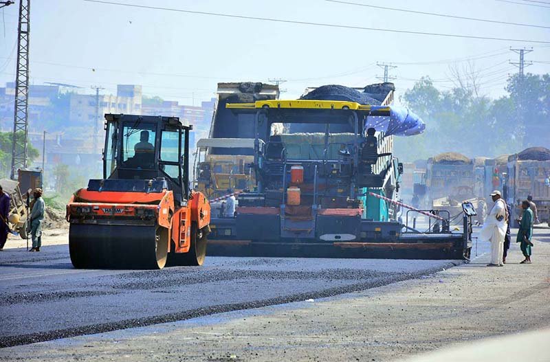 A view of construction work on a new road with heavy machinery at Boulevard Mall Road during development work in the city.
