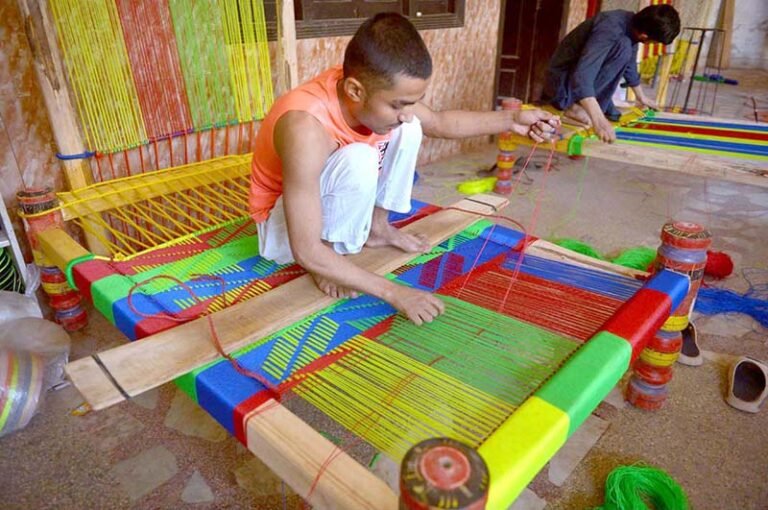 Worker makes a traditional woven bed, known as a Charpai, at a workshop in Dabgari area