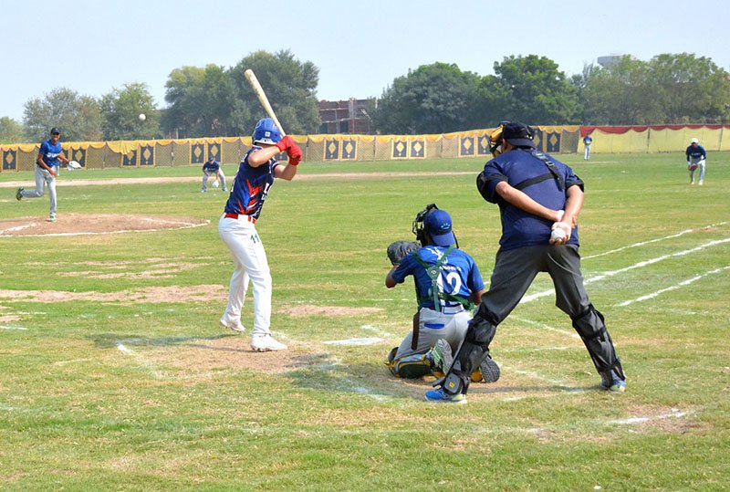 Players of the University of Central Punjab and the University of Management and Technology compete during the All-Pakistan Baseball Tournament organised by the Higher Education Commission (HEC) at MNS University of Agriculture.