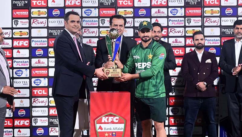 Minister of State for Interior, Talal Chaudhry presents the winning trophy to Pakistan captain Sahibzada Farhan after Pakistan won the three-match T20 series against Sri Lanka 2-1 at Rawalpindi Cricket Stadium