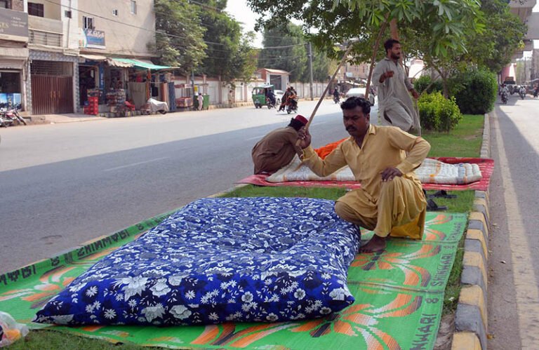 Workers press and stitch quilts ahead of the winter season to earn a livelihood.