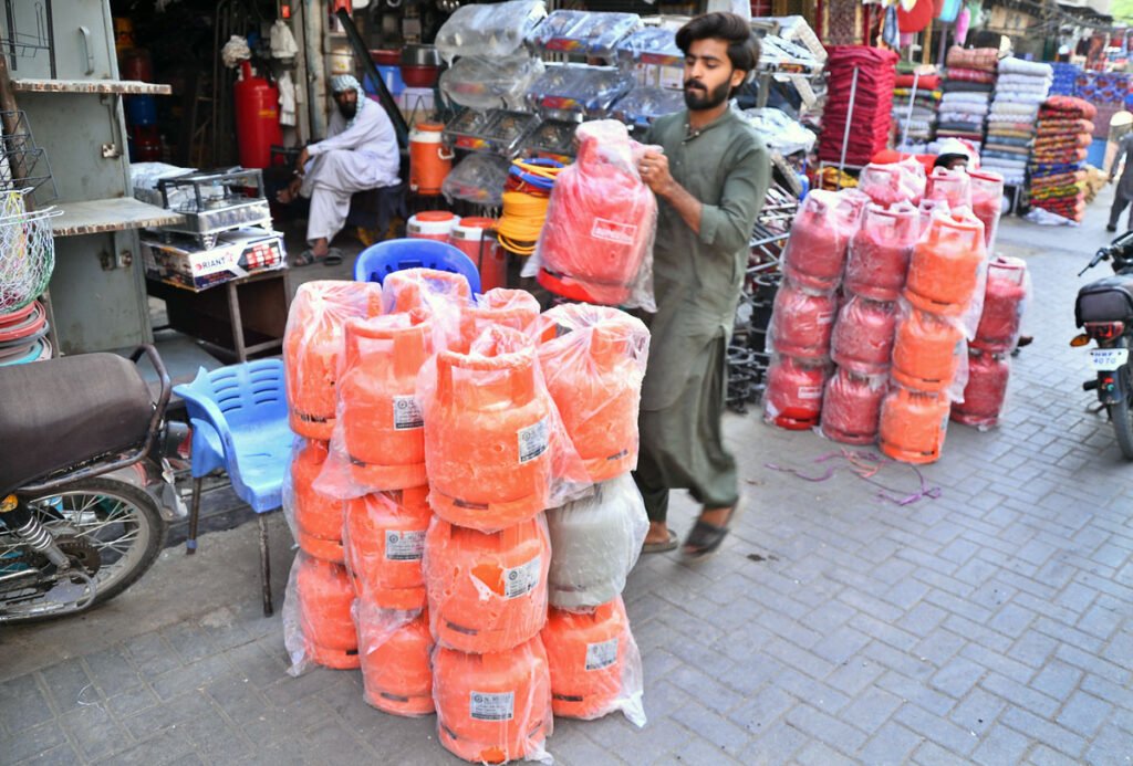 A vendor displays small gas cylinders for sale along Fort Road amid rising demand as winter approaches.