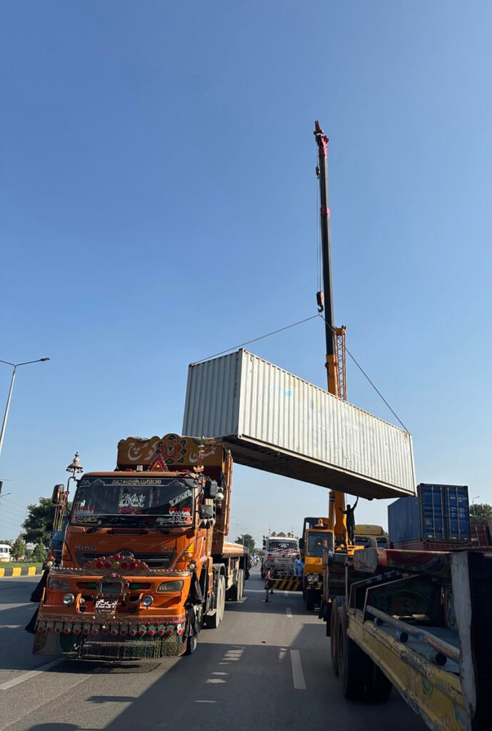 A crane lifts a container as authorities remove containers from the entry and exit routes of Federal Capital, on the administration’s orders.
