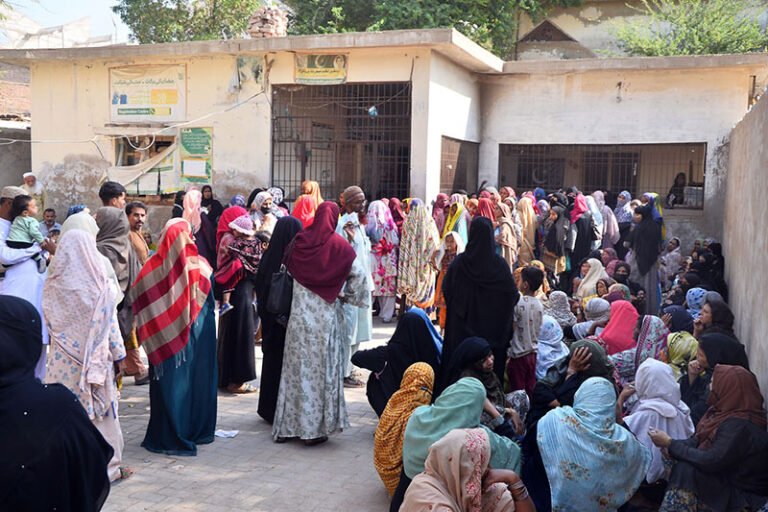 A large number of women wait to register for the Benazir Income Support Programme (BISP) in Latifabad
