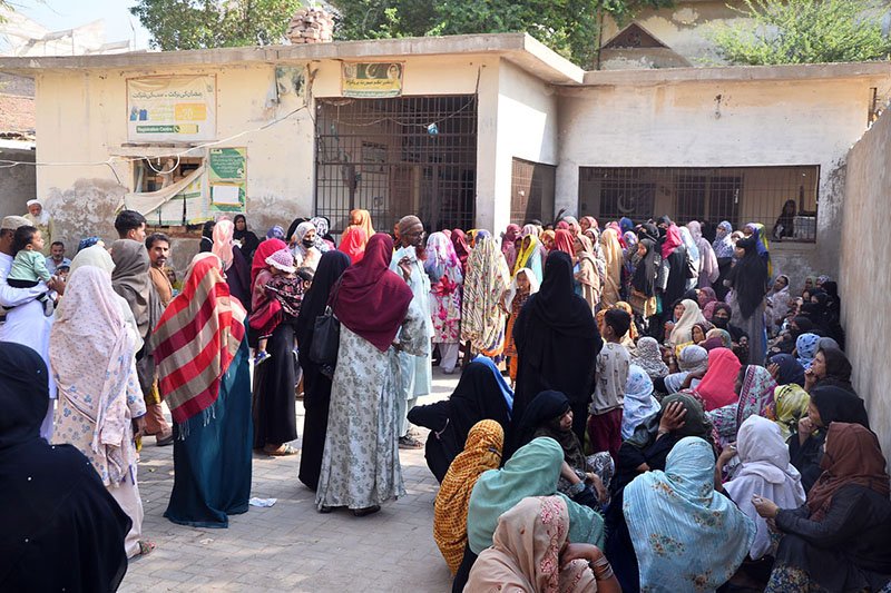 A large number of women wait to register for the Benazir Income Support Programme (BISP) in Latifabad