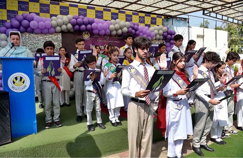 Head of The City School University Town Campus Mariam Khalid administers the oath to students during an investiture ceremony at the campus in the city