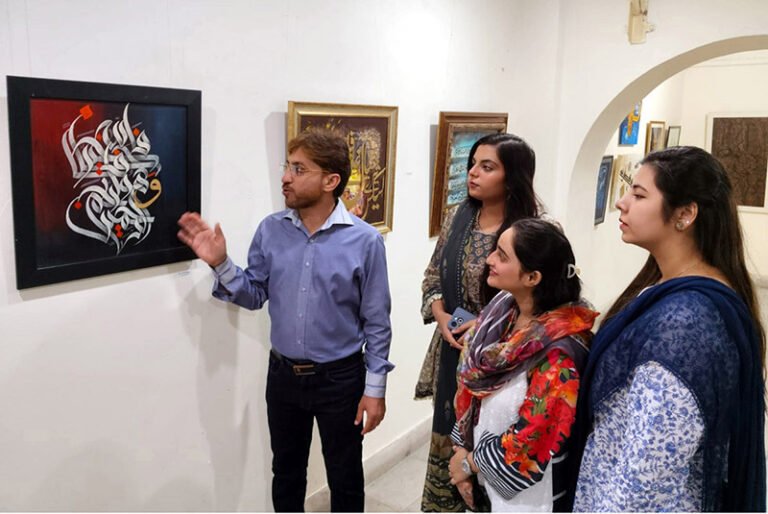 Visitors view calligraphy artworks at an exhibition organized by the Arts and Culture Forum (ACF) and the University of Home Economics in connection with the International Conference on Art and Design at Coopera Art Gallery, Mall Road