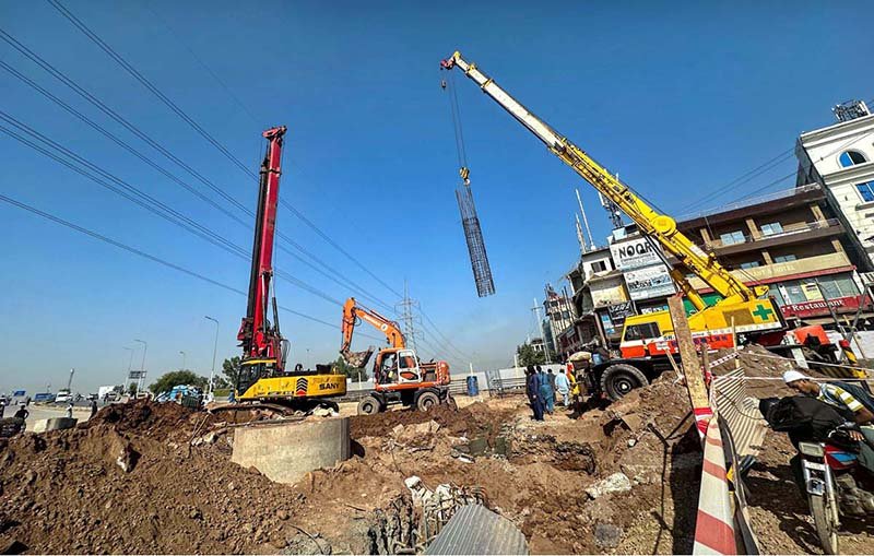 Heavy machinery is deployed near Khanna Pul in the federal capital for the construction of a service road connecting Faizabad to Gulberg Greens.