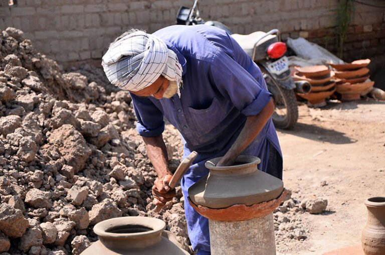 A worker preparing clay-made pitchers at his work place in kumharpara jamshoro road.