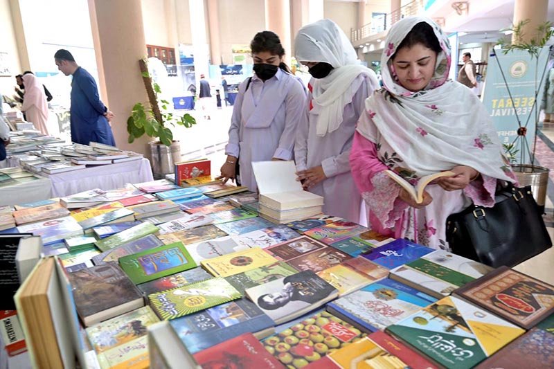Students and visitors taking keen interest in books at stall setup during 3rd International Seerat Festival, “International Seerat Conference”.