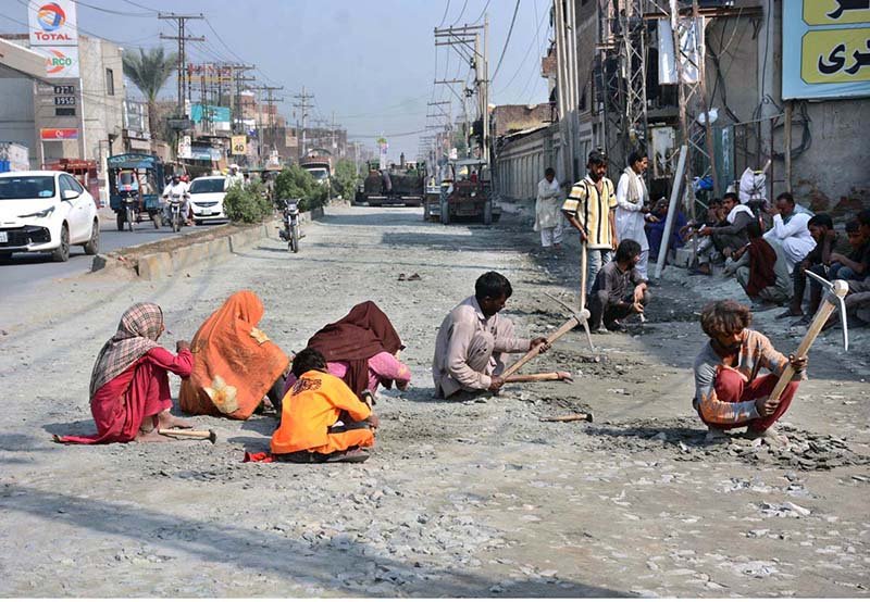 Labourers work on the underway Millat Road construction project as part of the city’s development work.