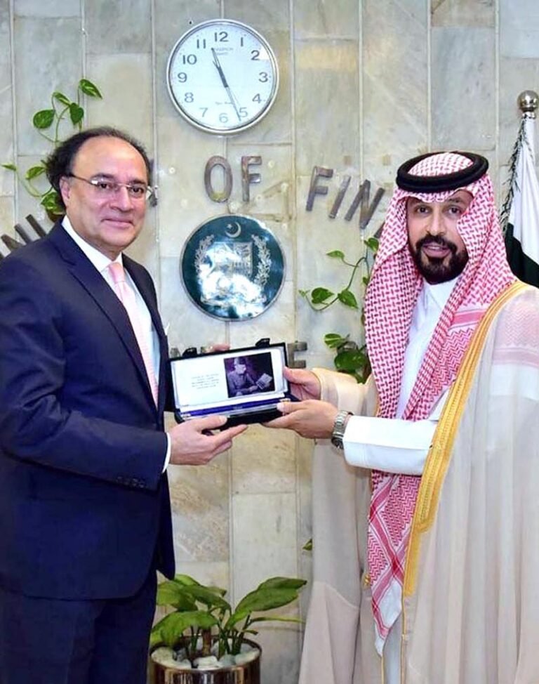 Federal Minister for Finance and Revenue, Senator Muhammad Aurangzeb, and Dr. Rajeh Tami Albugamy, Ambassador of the Kingdom of Saudi Arabia to Pakistan, exchanging souvenirs with each other.
