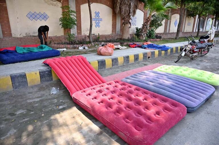 A vendor displaying air mattresses to attract customers near Khayam Chowk