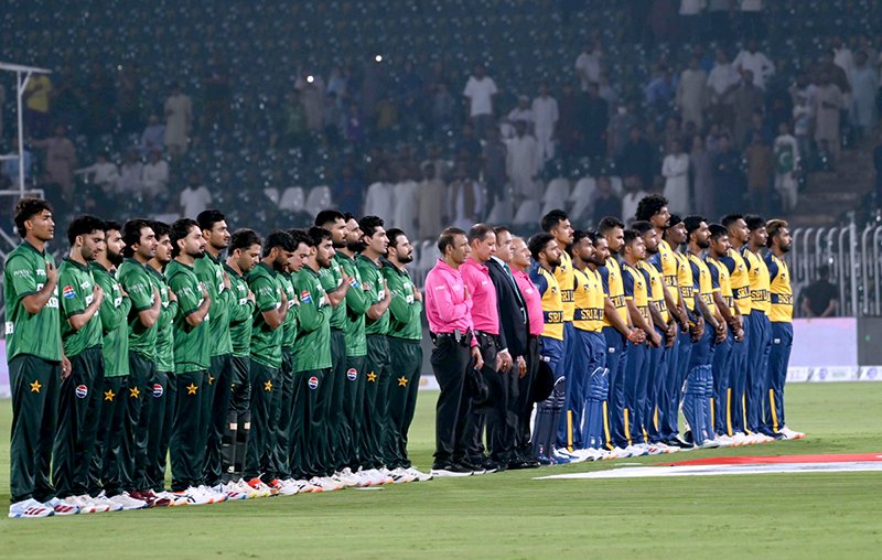 Cricket teams of Pakistan and Sri Lanka stand at attention as their national anthems are played before the start of the T20 International cricket match between the two sides at Rawalpindi Cricket Stadium.