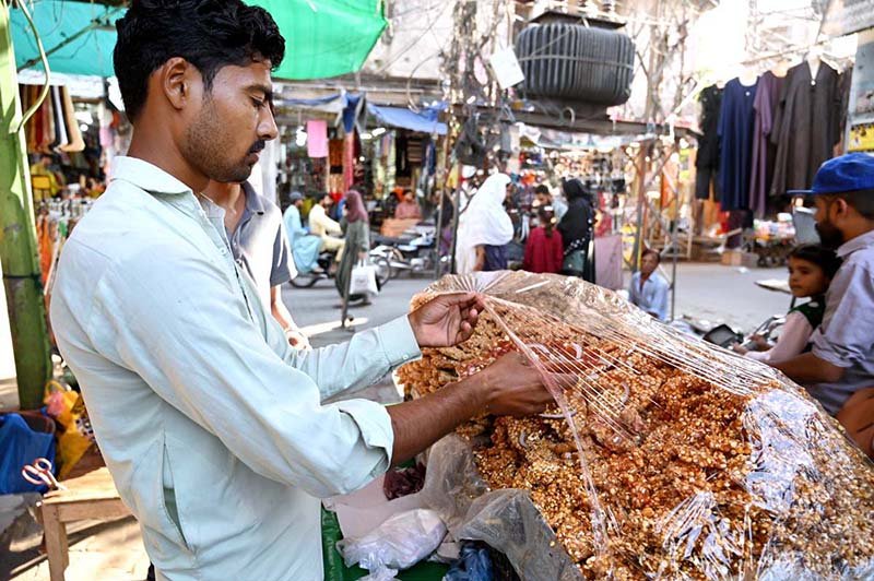 A street vendor sells Nuts Chikki, a traditional winter sweet made from nuts and sesame seeds