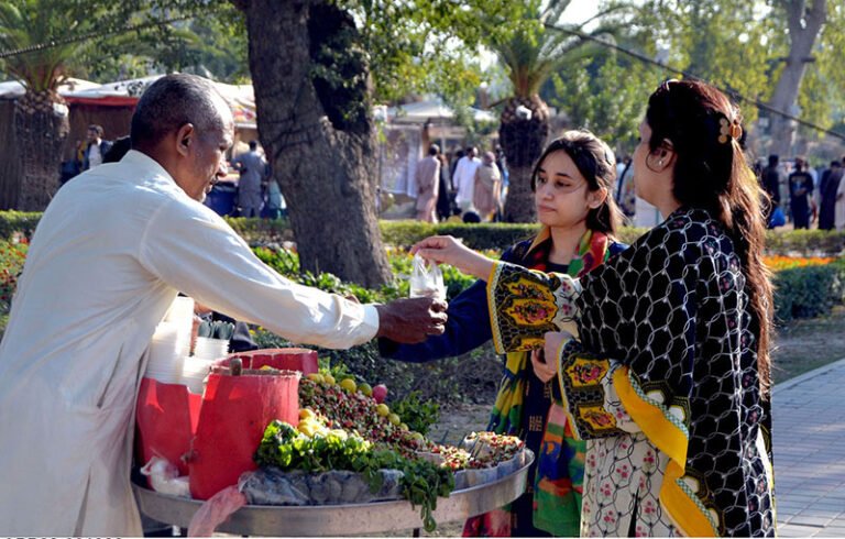 Women purchase traditional chana chaat (spicy chickpea salad) from a street vendor in the provincial capital.