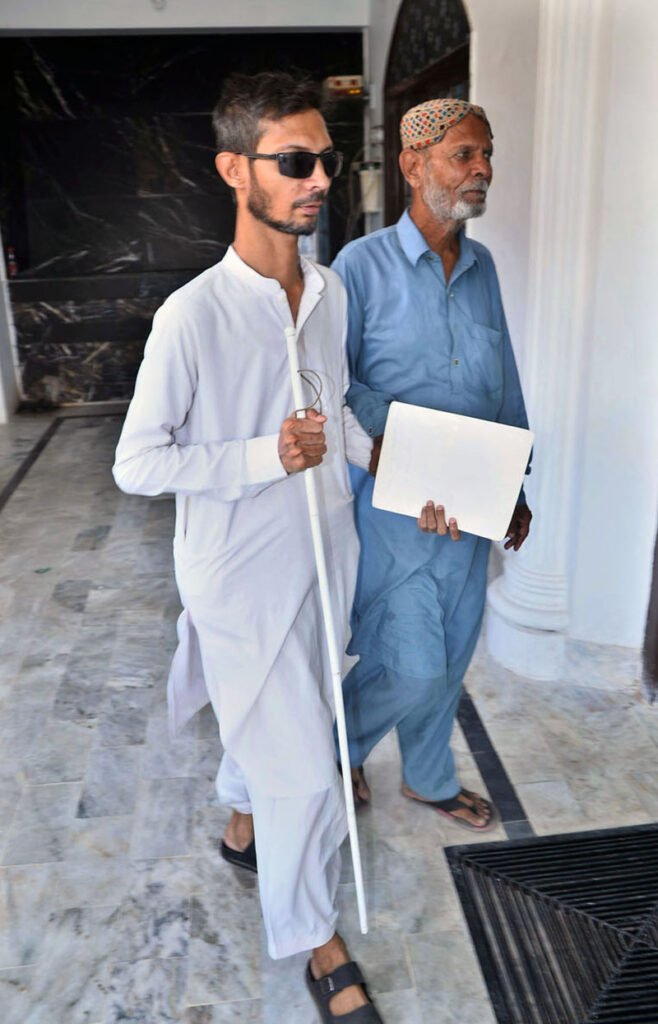 A visually impaired person walks with a white cane at a training center for people with visual impairments ahead of International White Cane Safety Day, observed.