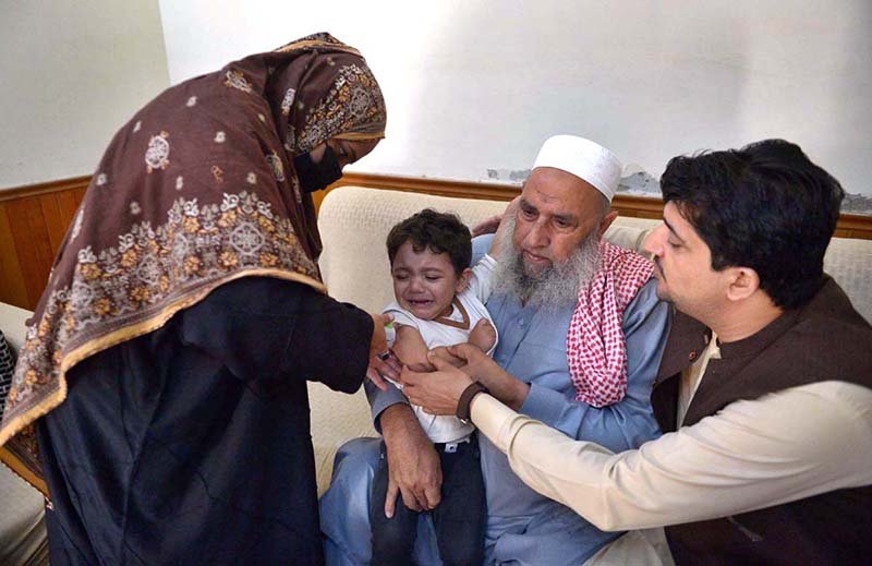 A child aged four months to 10 years receive fractional IPV booster doses, while those aged five months to 10 years are administered oral polio vaccine during an anti-polio campaign.