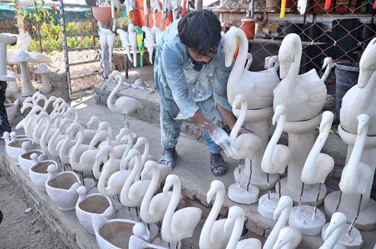 A vendor displaying animal statue after preparing to attract the customers at Eidgah road