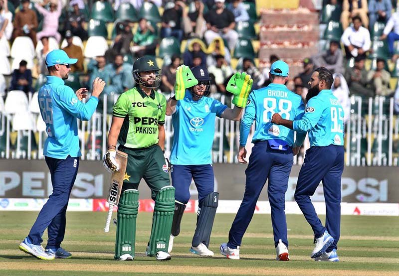 England players celebrate the dismissal of Pakistani batter Salman Ali Agha during the ODI Tri-Nation Series match between Pakistan and England at Rawalpindi Cricket Stadium