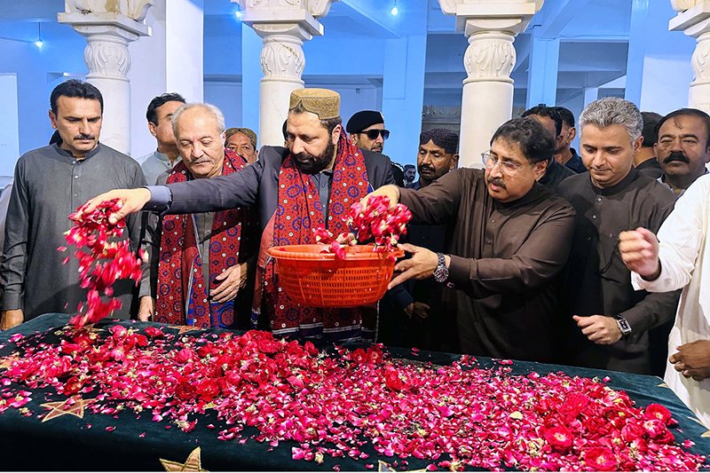 Chief Minister of Gilgit-Baltistan Amjad Hussain Advocate showering flowers at the grave of Shaheed Mohtarma Benazir Bhutto at Garhi Khuda Bakhsh Bhutto