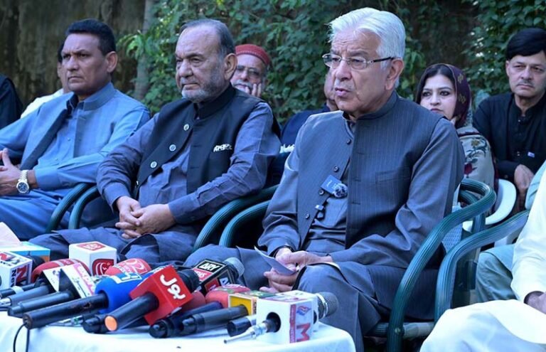 Defence Minister Khawaja Muhammad Asif talking to media persons at his liaison office in the Cantt area