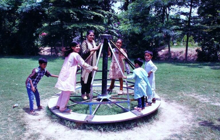 Children enjoying swings at a park in the city.