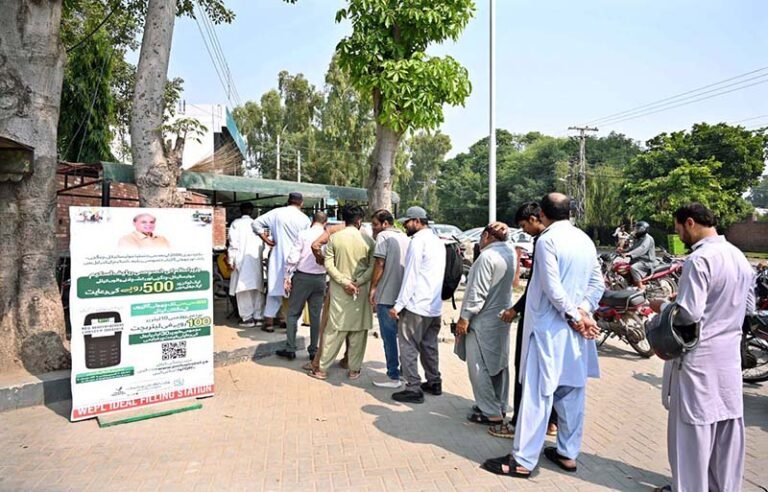 People are standing in queue for receiving petrol relief token at Club Road