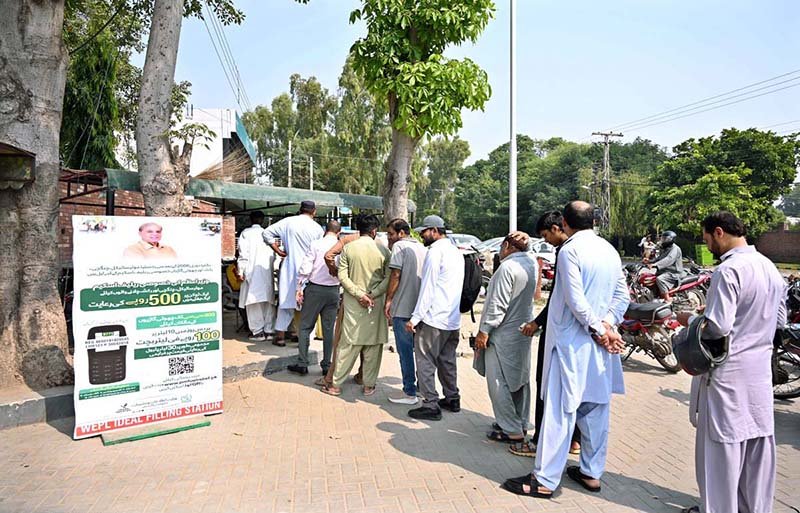 People are standing in queue for receiving petrol relief token at Club Road