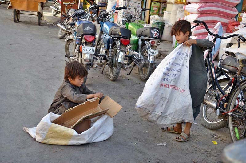 Children collecting empty boxes to sell in the market for livelihood at Mission Road