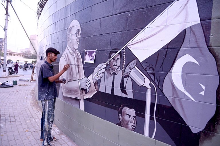 An artist paints a wall at the historic Sindh Governor House, adding colour and artistic expression to the surroundings during the beautification work in the provincial capital.