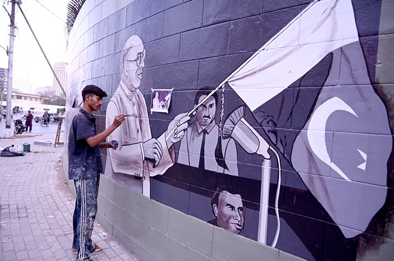 An artist paints a wall at the historic Sindh Governor House, adding colour and artistic expression to the surroundings during the beautification work in the provincial capital.