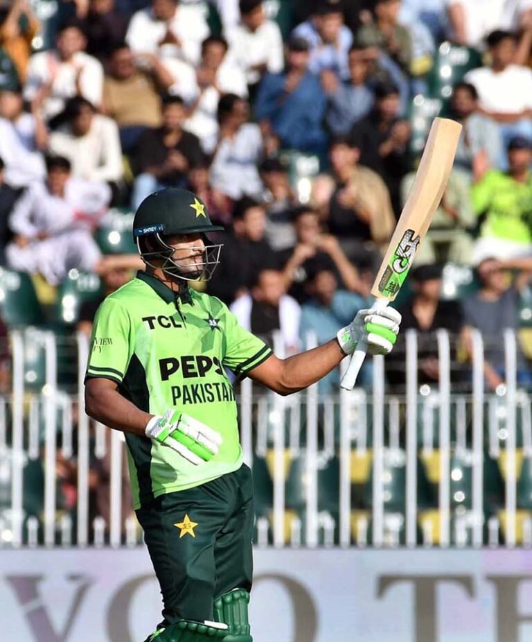 Pakistani batter Hasan Nawaz raises his bat to celebrate after scoring a half-century during the ODI Tri-Nation Series match between Pakistan and England at Rawalpindi Cricket Stadium