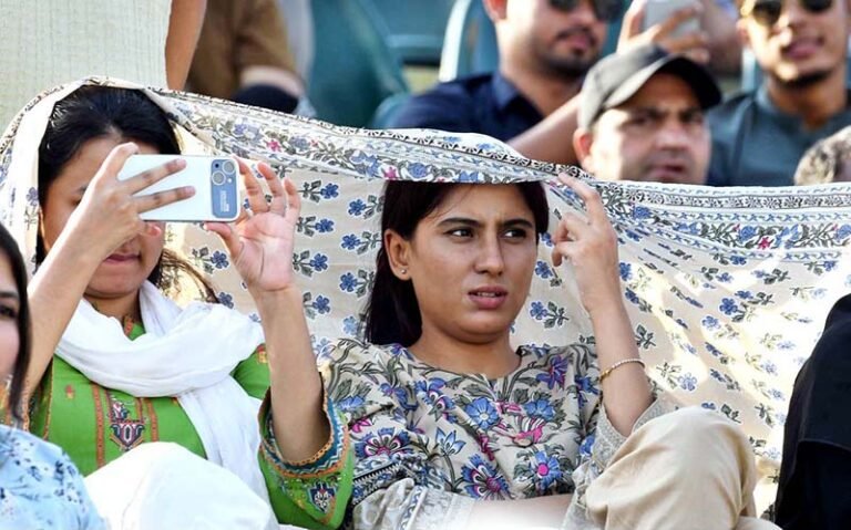 Spectators watch the cricket match between the England and Pakistan teams during the ODI Tri-Nation Series at Rawalpindi Cricket Stadium