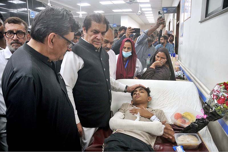 Federal Minister for Railways Muhammad Hanif Abbasi inquires about the health of an injured passenger during his visit to Nishtar Hospital following the derailment of the Rehman Baba Express near Sher Shah Railway Station