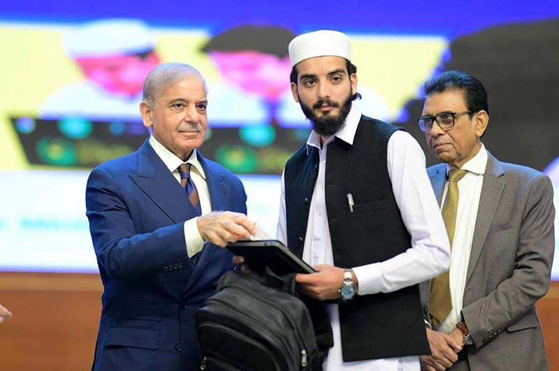Prime Minister Muhammad Shehbaz Sharif hands over Chromebooks and Mifi devices to brilliant students from Madrassas and schools