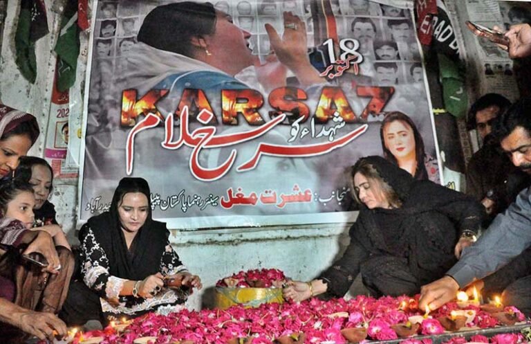 Pakistan People’s Party (PPP) women workers light lamps in memory of the Karsaz tragedy martyrs outside a press club