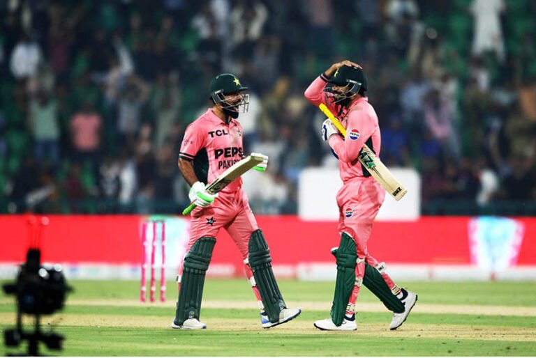 Pakistani batsman Shadab Khan and Haris Rauf happy after review decision (not out) during the one-day international (ODI) tri-series cricket match between England and Pakistan at the Gaddafi Cricket stadium